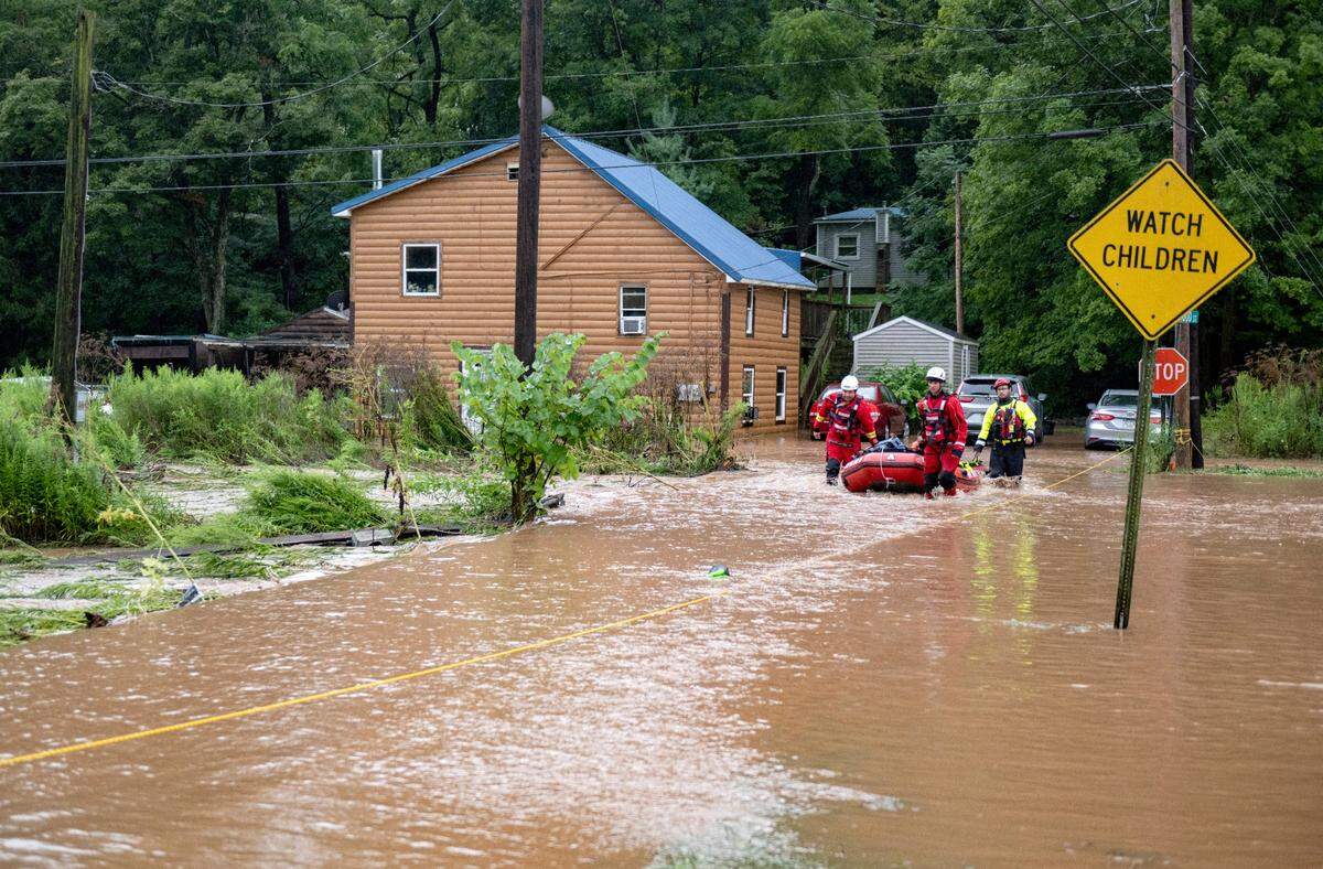 Howard Fire Company performs a specialized rescue for residents of a home on Buttonwood Street in Unionville as Dewitt Run floods on Friday, August. 9, 2024.