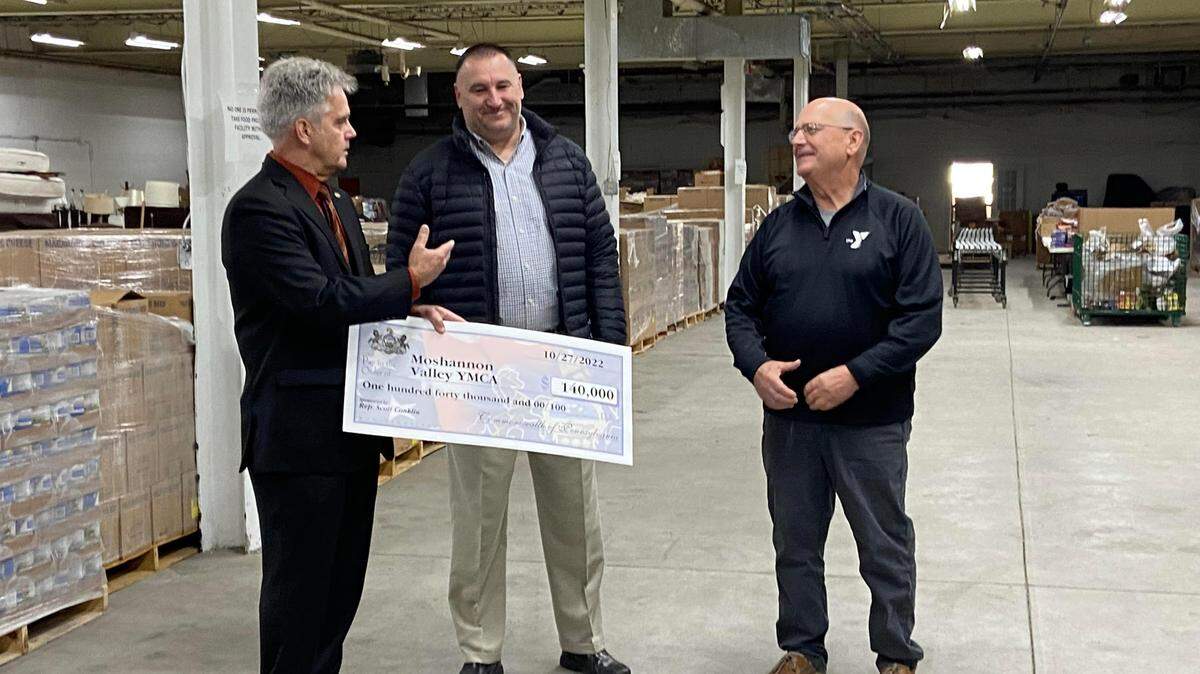 State Rep. Scott Conklin, left, presents Scott Mitchell, center, and Mel Curtis with a $140,000 grant for the Moshannon Valley YMCA.