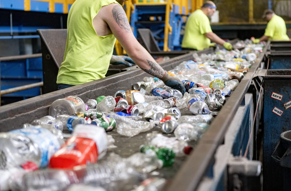 Workers sort out items that won’t be recognized by the Alchemy artificial intelligence system before the conveyor belt continues to the new machinery at the Centre County Recycling and Refuse Authority on Tuesday, July 7, 2026. Before the Alchemy system, all items were sorted by hand.
