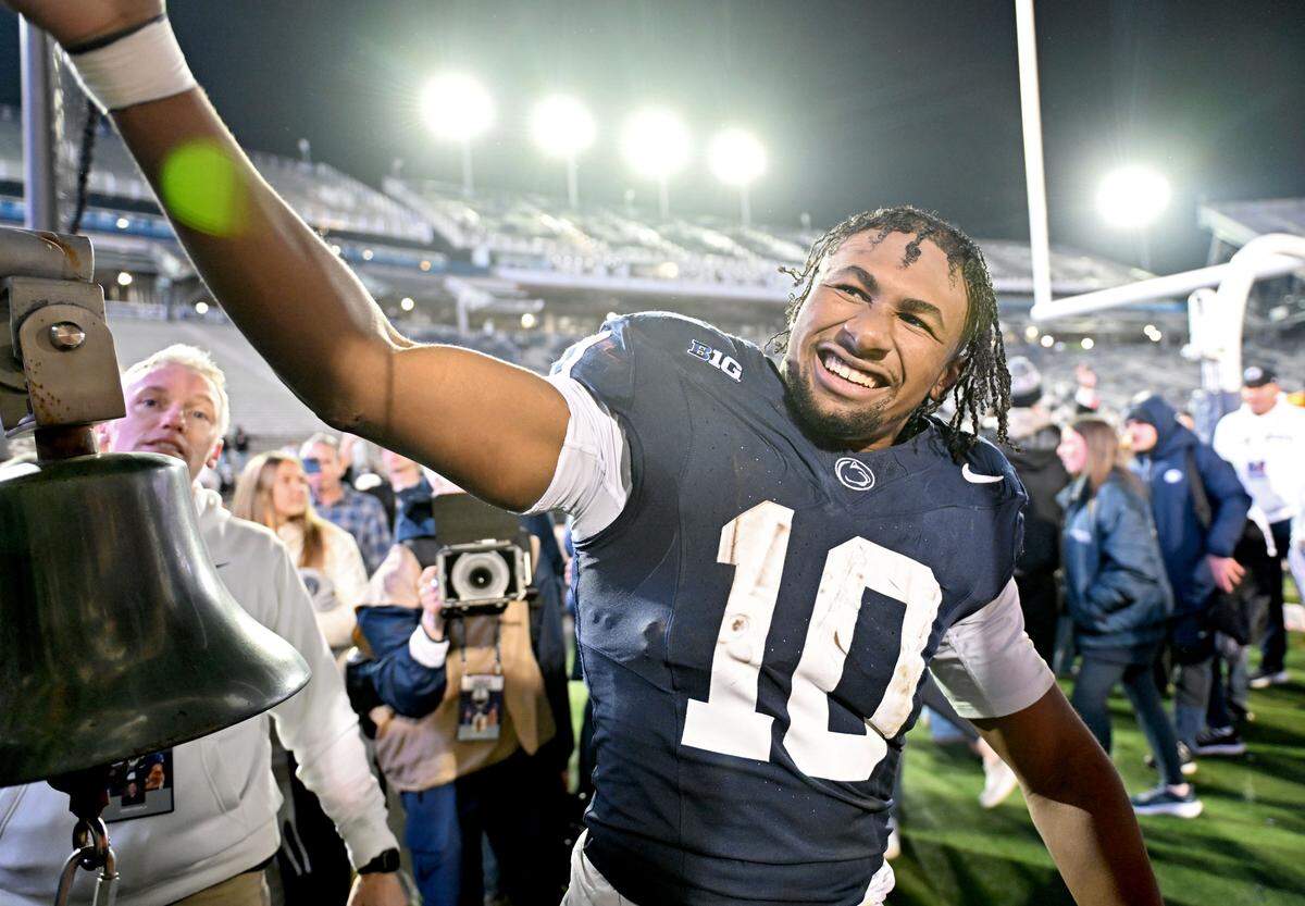 Penn State running back Nick Singleton high-fives fans  after the win over Nebraska on Saturday, Nov. 22, 2025 at Beaver Stadium.  