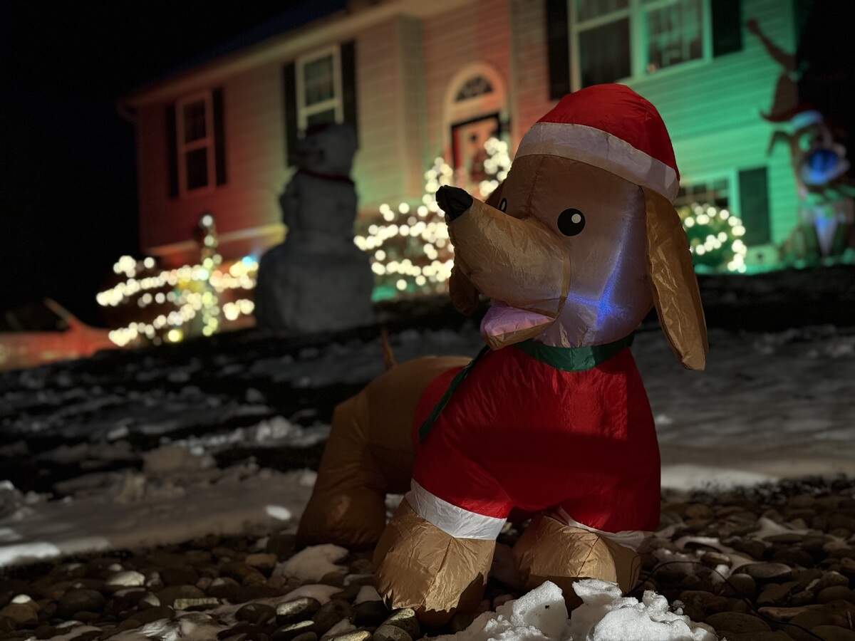 A dachshund inflatable stands in front a snowman at 125 Arbor Bluff Drive, Pleasant Gap, on Dec. 4, 2025.