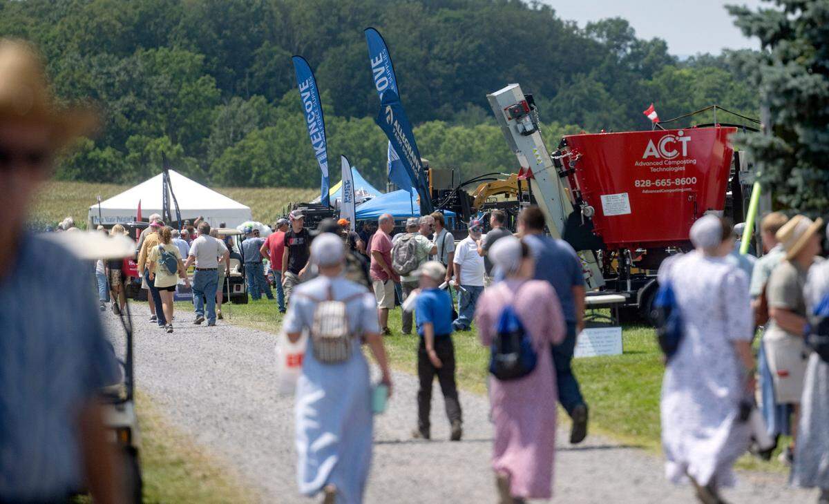Visitors walk along the displays at the Penn State Ag Progress Days on Wednesday, Aug. 9, 2023.