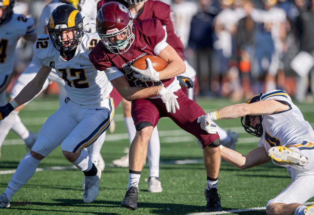 Mt. Lebanon defenders try to stop State CollegeÕs TJ Yoder during the PIAA class 6A semifinal game on Saturday, Dec. 4, 2021 at Mansion Park. Mt. Lebanon won, 49-28.