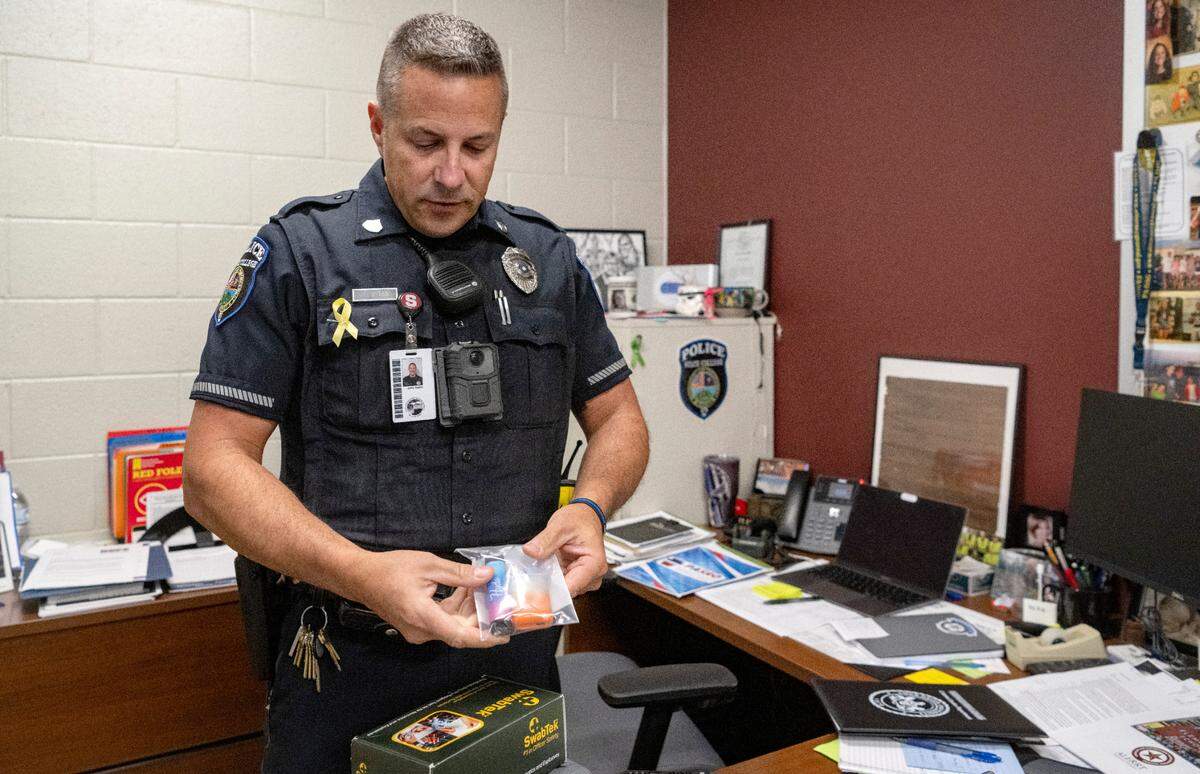 State High school resource officer John Aston shows an assortment of vapes that have been confiscated from students.