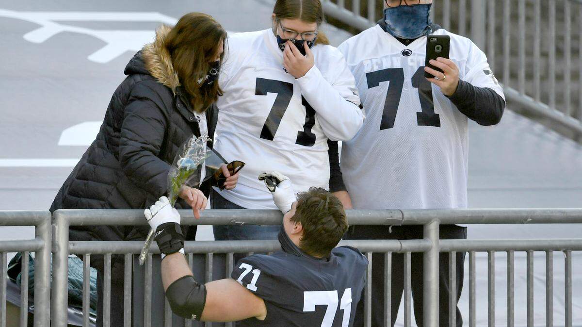 Penn State offensive lineman Will Fries greets his family after being introduced for senior day before the Michigan State game on Saturday, Dec. 12, 2020 at Beaver Stadium.