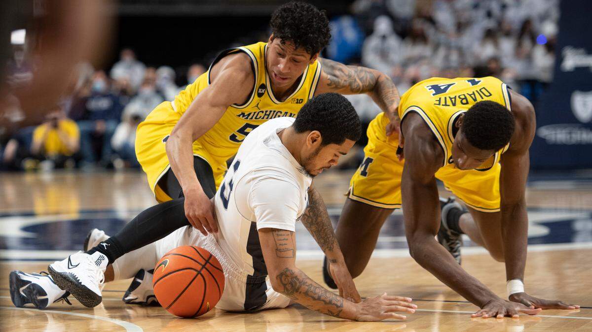 Penn State guard Sam Sessoms (3) battles Michigan guard Eli Brooks (55) and Michigan forward Moussa Diabate (14) for the ball during Tuesday’s game at the Bryce Jordan Center.