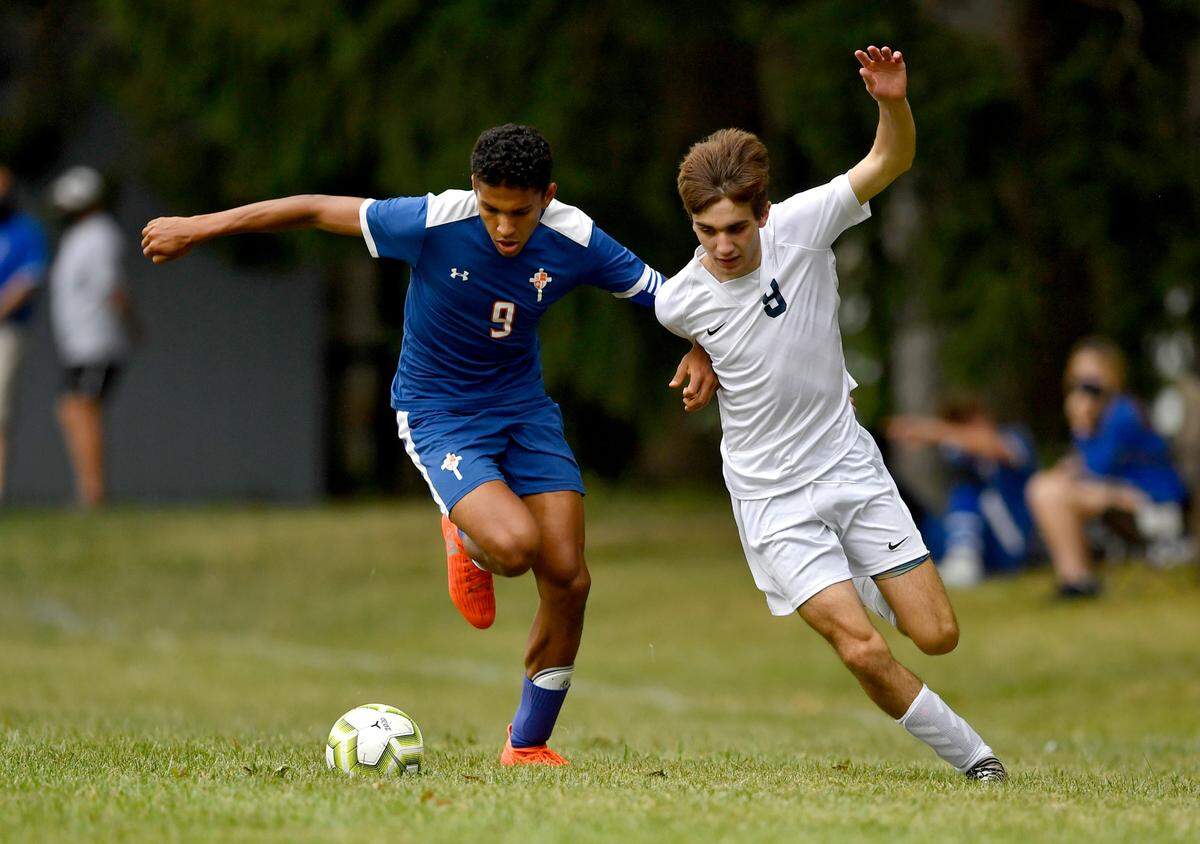 Saint Joseph’s Jonah Clark and Philipsburg-Osceola’s Ashton Crownover fight for the ball during the game on Thursday, Sept. 17, 2020.