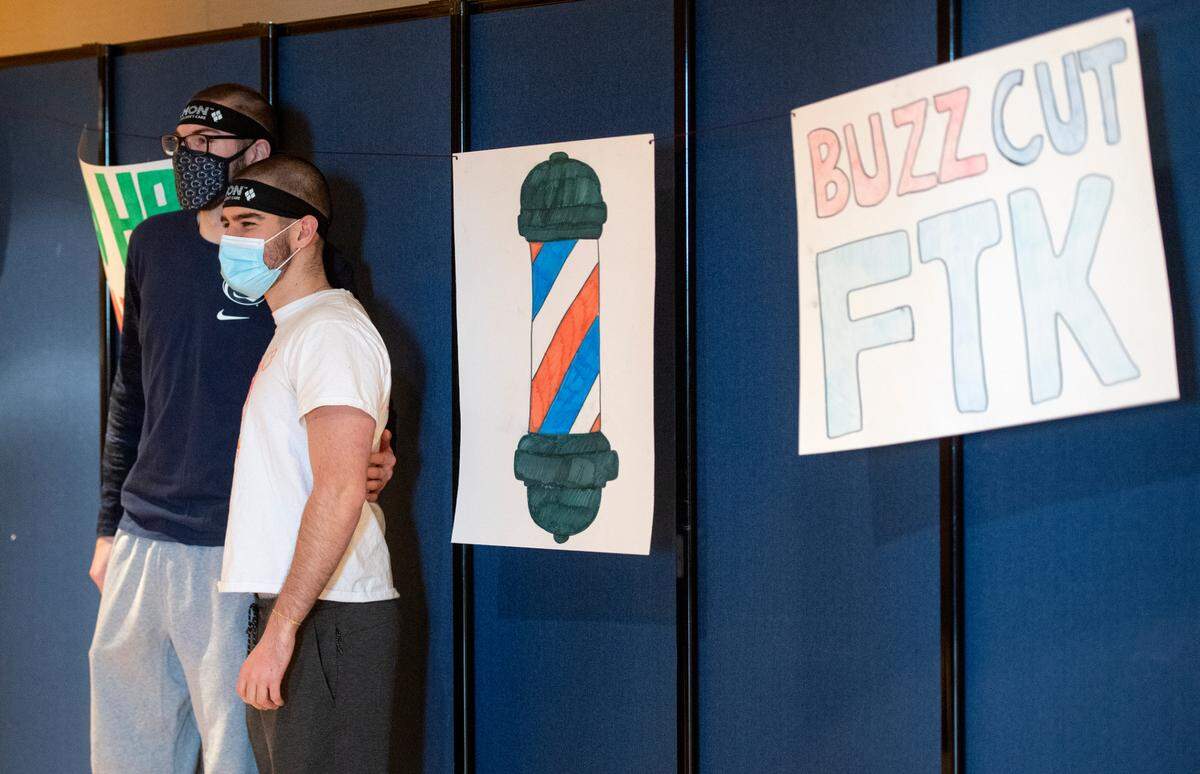 Friends pose together for photos after getting buzz cuts Tuesday during the Penn State Thon “No Hair, Don’t Care” event.