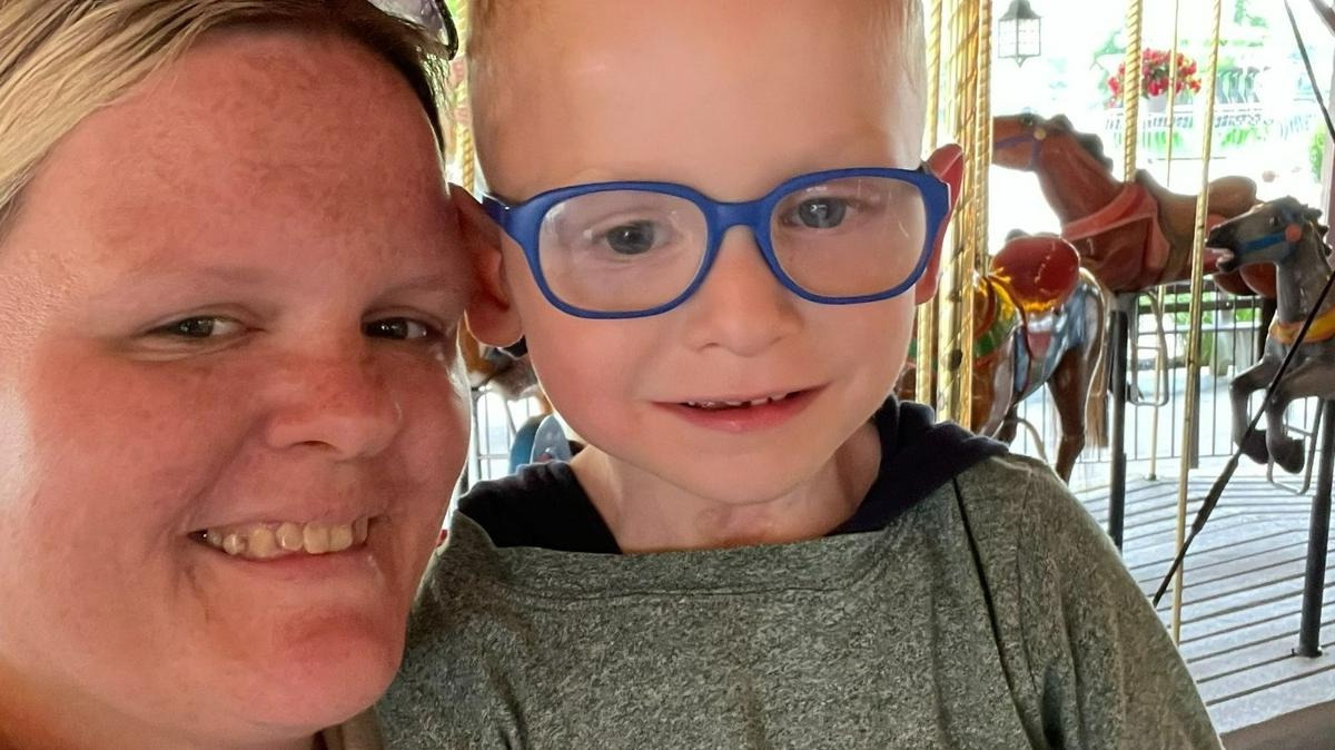 Aiden Getz and his mother, Stacie Teschler, enjoy a carnival ride. Aiden was named a 2022 Children’s Miracle Network Miracle Kid.