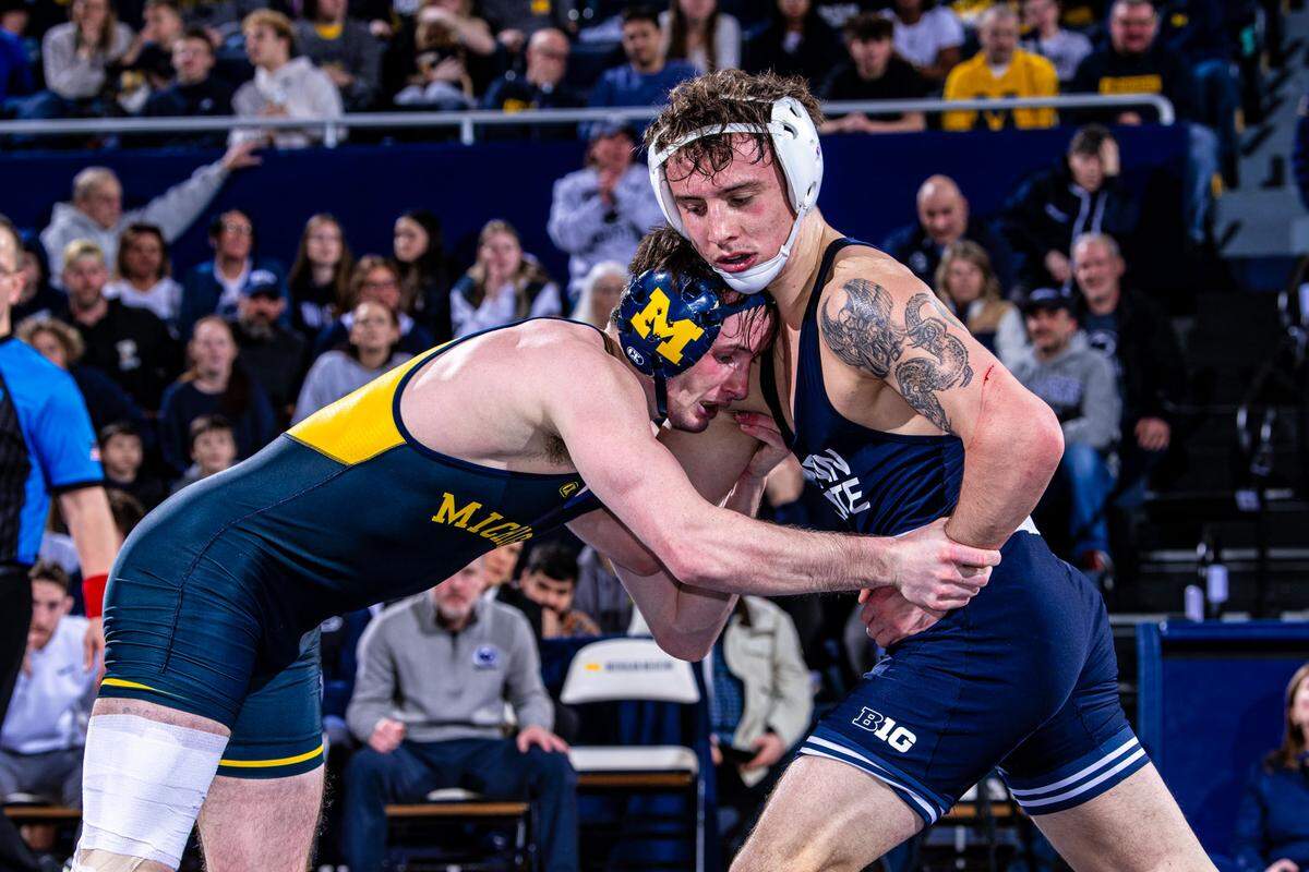 Penn State’s Nate Desmond battles with Michigan’s Dylan Ragusin in their 141-pound bout of the Nittany Lions’ 38-3 win on Friday in Ann Arbor, Mich. Desmond topped Ragusin, 8-5, in sudden victory.