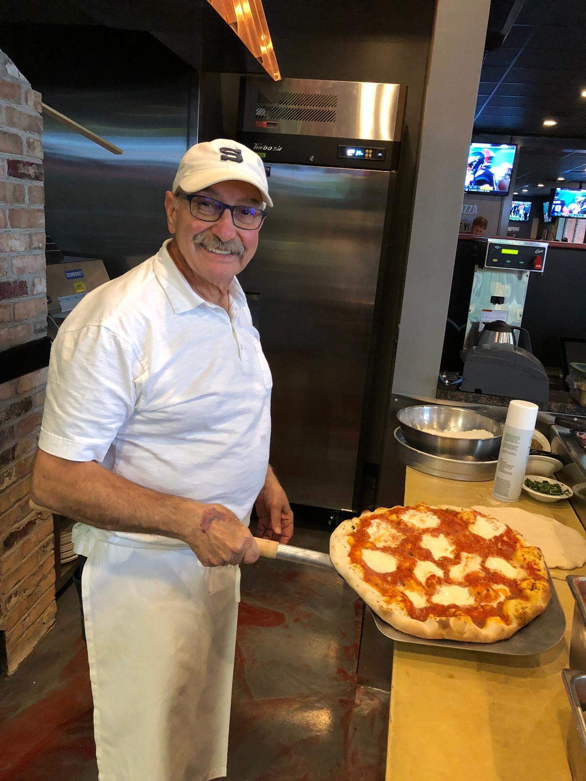 Andy Zangrilli cooks a pizza at his newest location, HiWay Pizza Pub West, which opened in 2017.