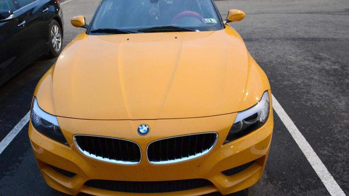 A yellow BMW is one of many luxury cars parked at The Heights.
