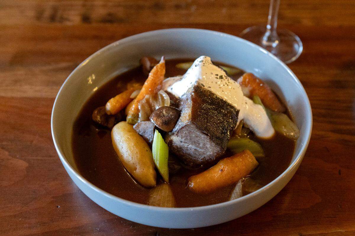 The Ten Point braised short rib pot roast with vegetables and fingerling potatoes and a horseradish cream along with a glass of Seven Mountains Ten Point at Pass The Dutchie in Reedsville on Thursday, Dec. 12, 2024.
