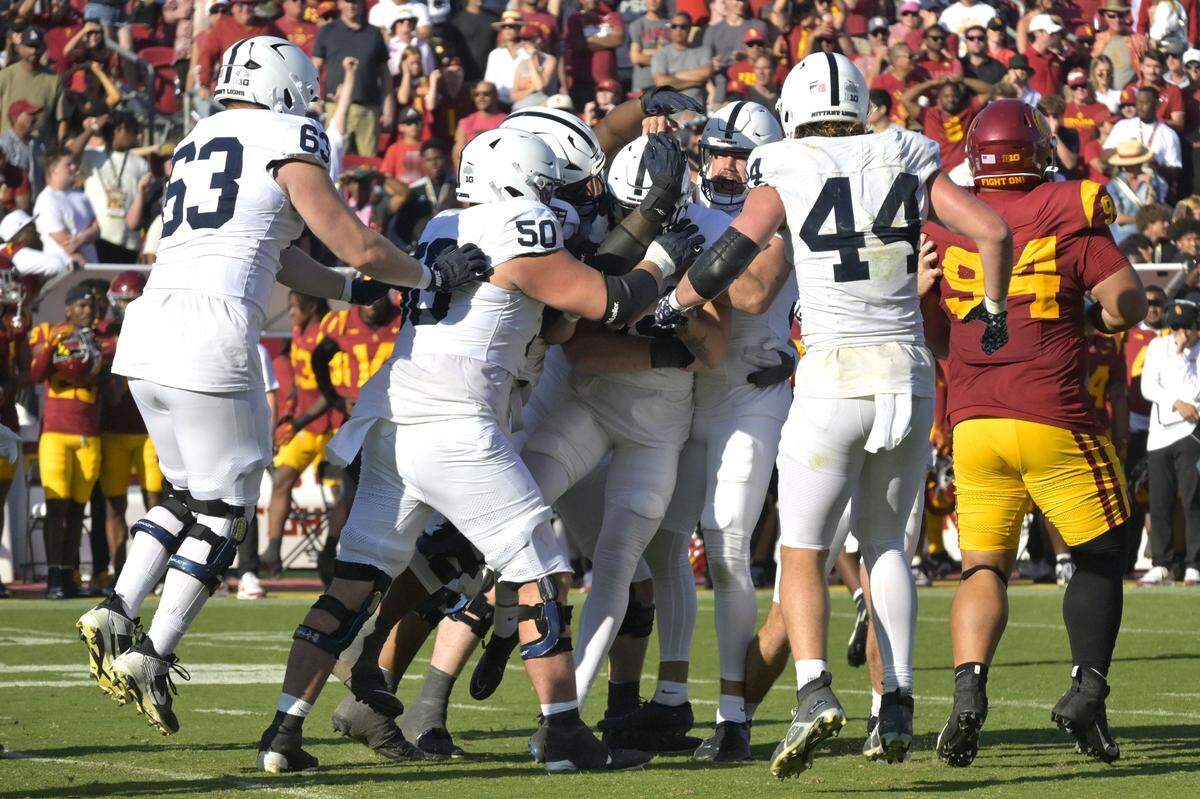 Oct 12, 2024; Los Angeles, California, USA; USC Penn State Nittany Lions place kicker Ryan Barker (94) is congratulated after hitting the winning field goal in overtime to defeat the USC Trojans at United Airlines Field at the Los Angeles Memorial Coliseum. Mandatory Credit: Jayne Kamin-Oncea-Imagn Images