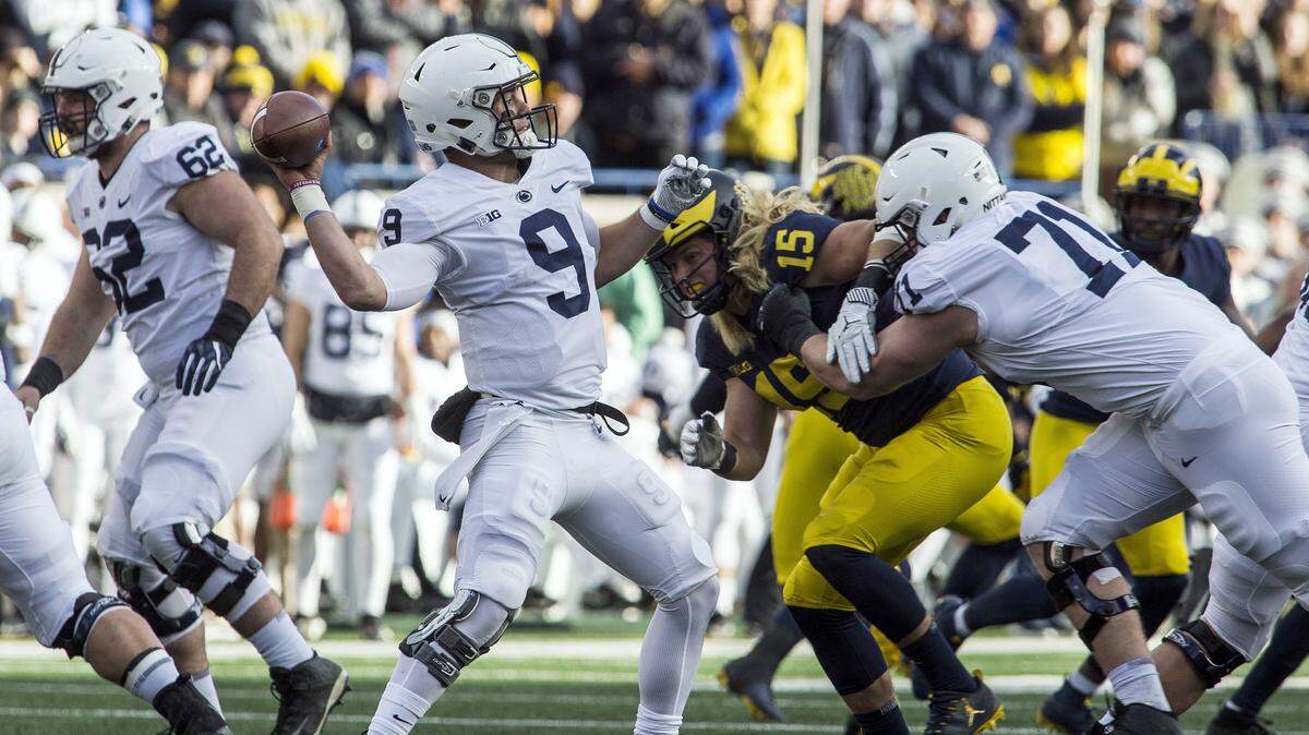 Penn State quarterback Trace McSorley (9) throws a pass, aided by a block from offensive lineman Will Fries (71) on Michigan defensive lineman Chase Winovich (15), in the second quarter of an NCAA college football game in Ann Arbor, Mich., Saturday, Nov. 3, 2018. (AP Photo/Tony Ding)