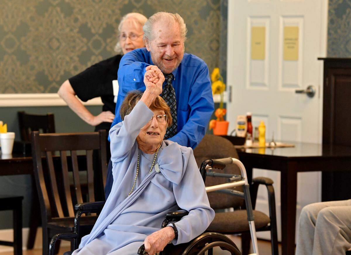 Ralph Savarese twirls Jo Ganley in her wheelchair during the “senior prom” Friday at Wynwood House in Boalsburg.