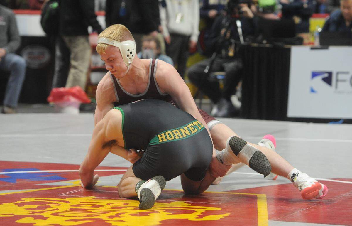 State College’s Pierson Manville works on a takedown of Emmaus’ Nick Velde in their 138-pound second round match of the PIAA Class 3A Championships on Thursday, March 10, 2022 at Giant Center in Hershey. Manville pinned Velde in 2:17.