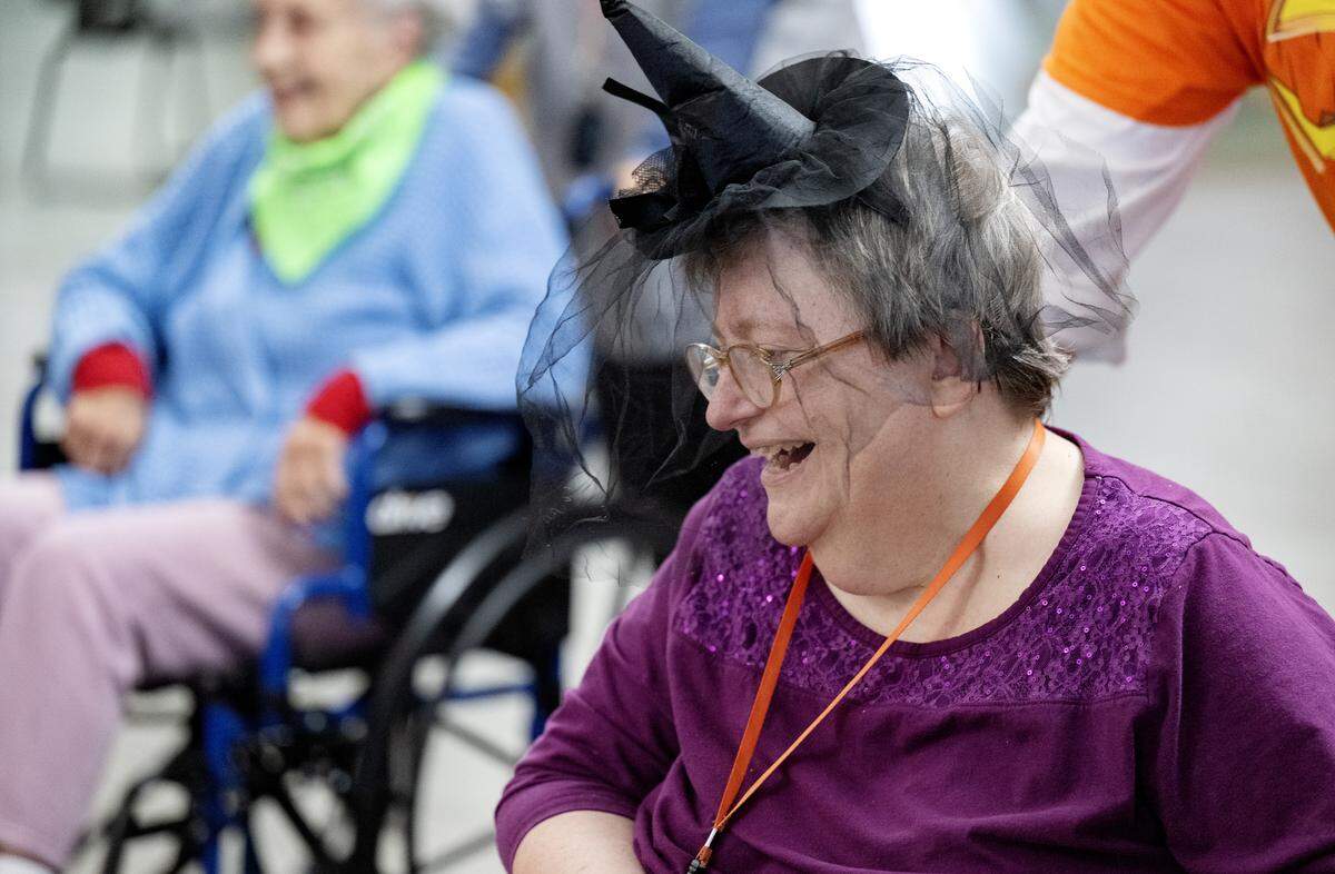 Amy Ripka laughs as she is pushed in her wheelchair by Cory Geishauser during square dancing at the Wynwood House in Centre Hall on Thursday, Oct. 30, 2025. 