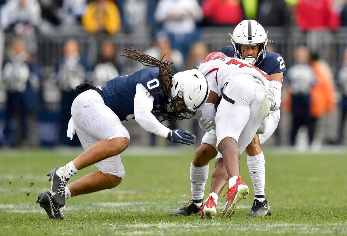 Penn State safeties Jonathan Sutherland and Keaton Ellis stop Rutgers wide receiver Bo Melton during the game on Saturday, Nov. 20, 2021.