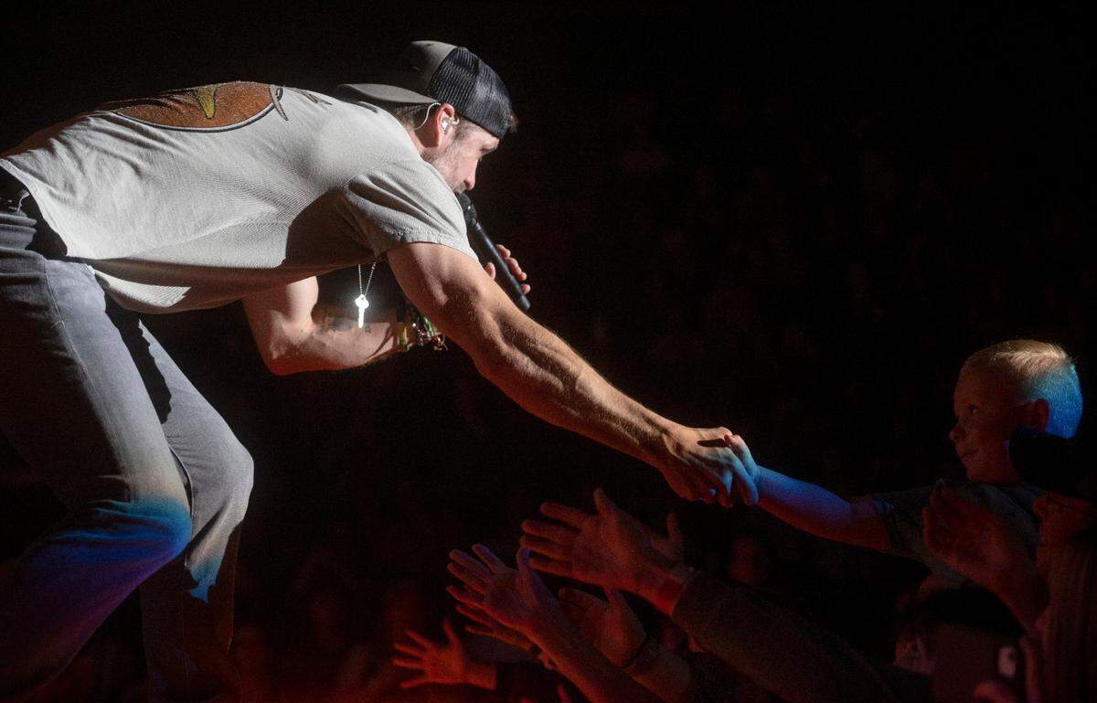 Walker Hayes shakes hands with a young fan as he performs at the Bryce Jordan Center as part of the Duck Buck Tour on Thursday, April 27, 2023.