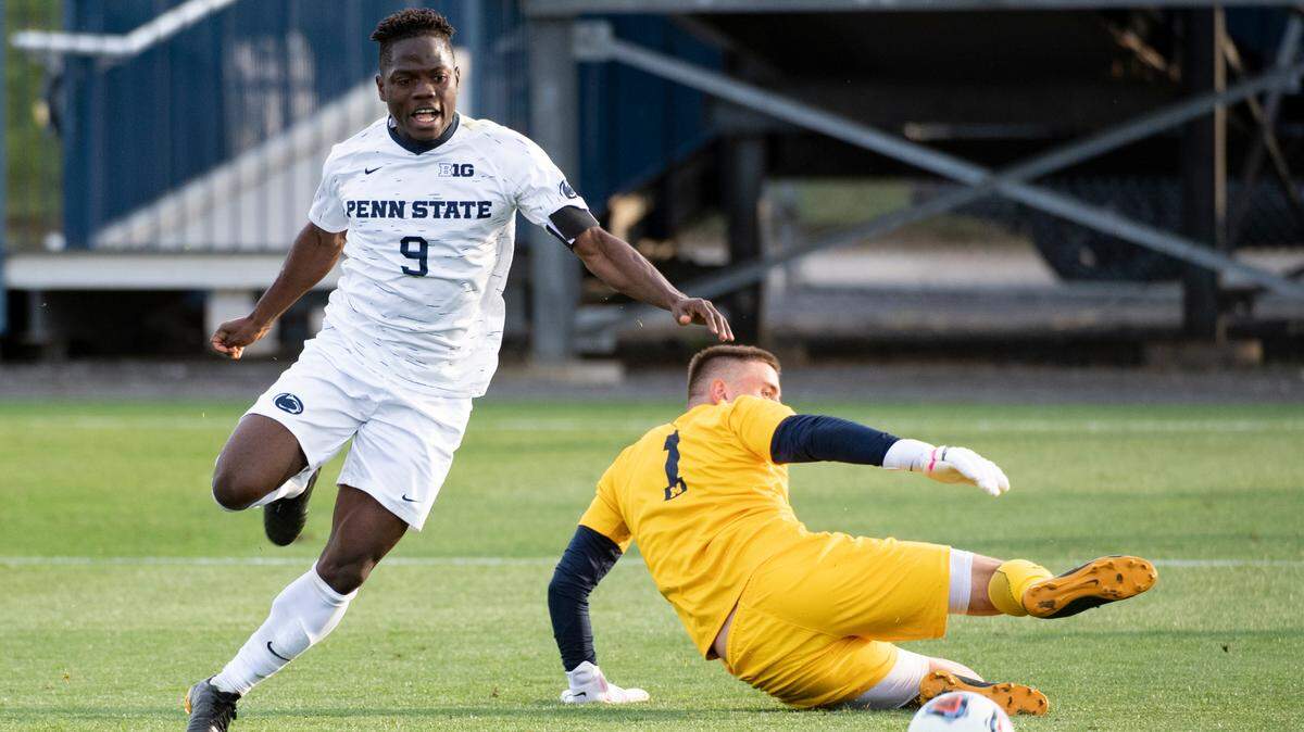 Penn State forward Daniel Bloyou (9) dribbles past the Michigan goalkeeper Owen Finnerty (1) during the Big Ten Men’s Soccer Tournament Quarterfinal match at the Jeffrey Field on Wednesday, April 14, 2021 in State College, PA. The Nittany Lions defeated Michigan 4-1 to move on to the Big Ten Tournament Final.