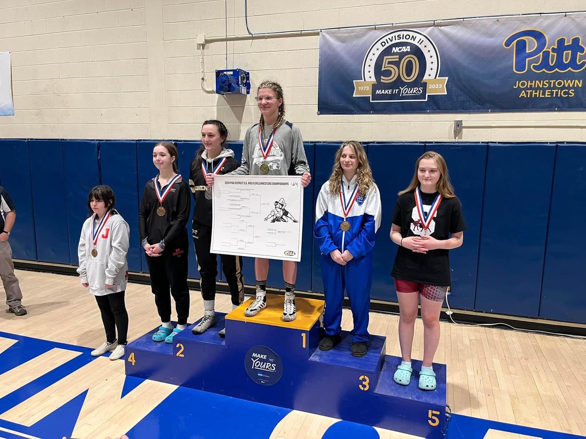 Philipsburg-Osceola’s Isabell DuVall celebrates her first District 5/6/9 title after winning the 124 pound weight class on Saturday at the University of Pittsburgh-Johnstown. DuVall pinned Curwensville’s Savannah Carfley in 3:29 for the win. State College’s Christine Armstrong finished fifth in the same weight.