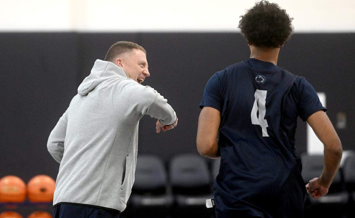 Penn State men’s basketball coach Mike Rhoades jokes with Puff Johnson as the team warms up for a summer workout on Tuesday, July 11, 2023.