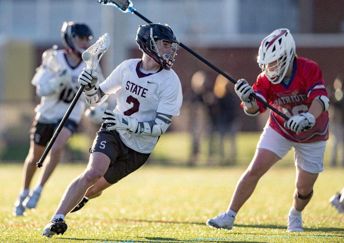 State College’s Ty Salazer cuts down the field with the ball around a Red Land defender during the game on Thursday, April 25, 2024.