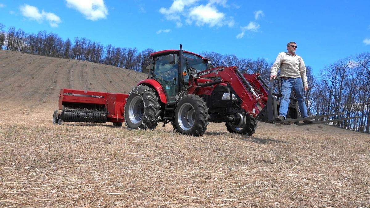 Andy Bater, 58, stands with his tractor on April 10, after harvesting switchgrass, which he sells as mulch.