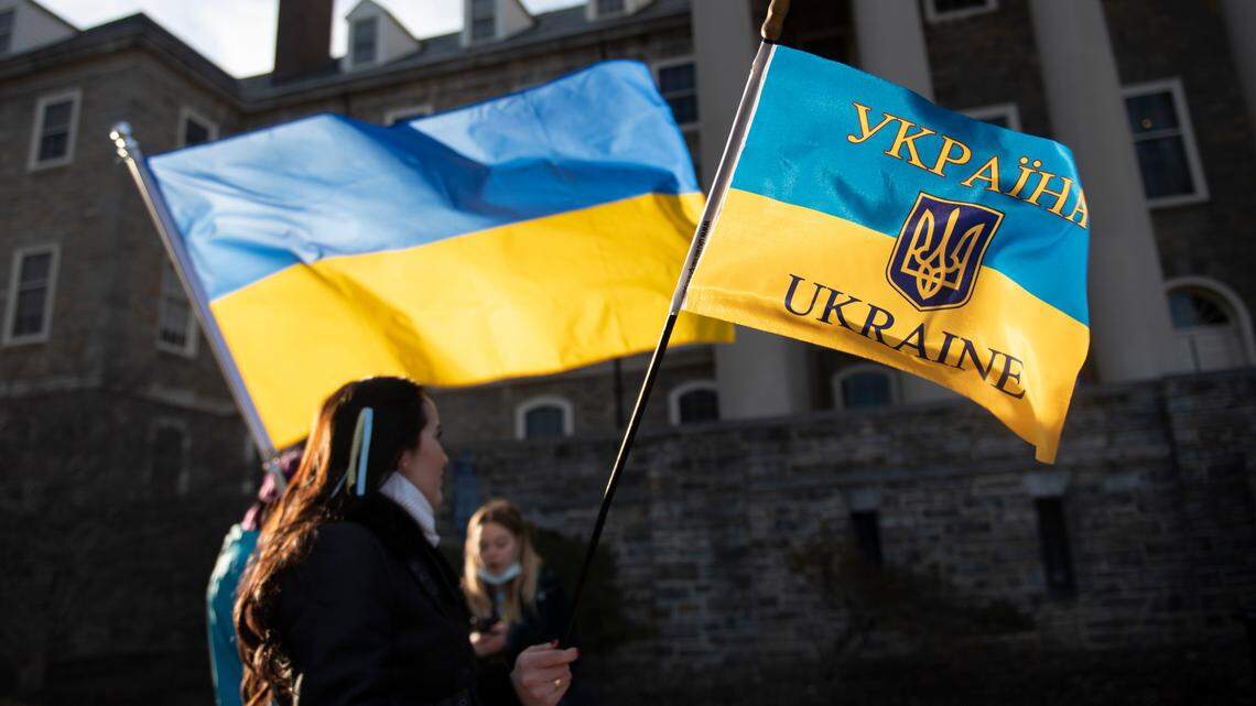 Nelia Mihai holds a Ukrainian flag Thursday during a rally hosted by the Ukrainian Society at Penn State in front of Old Main.