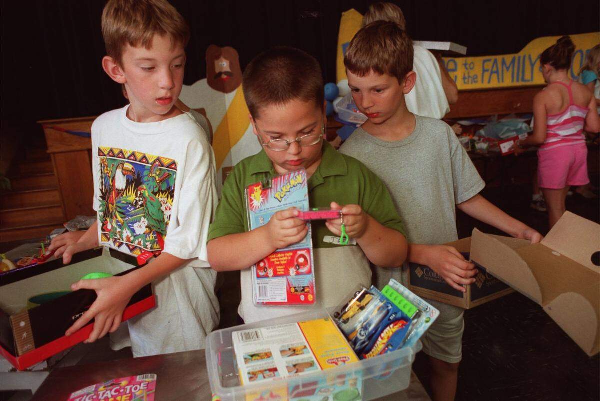 Marc McMullen, 9, right, pauses while taking a break from making Jared Boxes, in honor of his 6-year-old brother who died from cancer. With him at Our Lady of Victory Catholic Church’s vacation Bible school are Kyle Surovec, 9, of Boalsburg, left, and Joey Oehlert, 8. of Bridgeport. This photo was taken June 20, 2001.