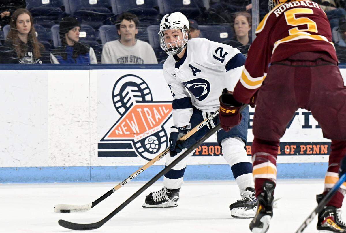Penn State's Ben Schoen looks to make a pass around a Minnesota defender during the game on Wednesday, March 11, 2026 at Pegula Ice Arena. 
