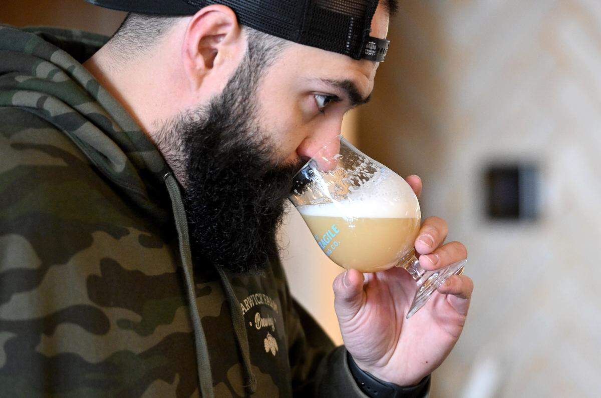 Paulo Nami, the head brewer at Antifgragile Brewery Company, smells the flavors of one of the beers he is working on Tuesday, Nov. 28, 2023.