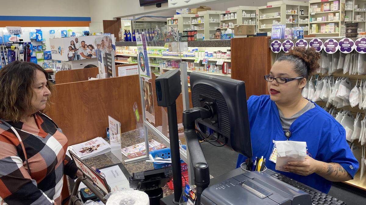Customer Lisa Durs is helped by pharmacy clerk Kira Tomoney at Minnich’s Pharmacy in York County.