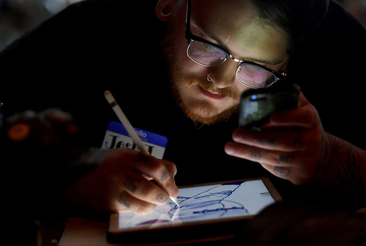Josh Jozefick draws on his iPad during Drink and Draw at the Champs on North Atherton Street on Wednesday, July 25, 2018.