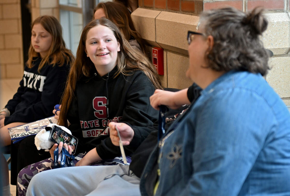 Taryn Brenner, 11, laughs with her mom while visiting the Penn State Berkey Creamery during Penn State’s Bring Our Children to Work Day on Monday, April 13, 2026.  