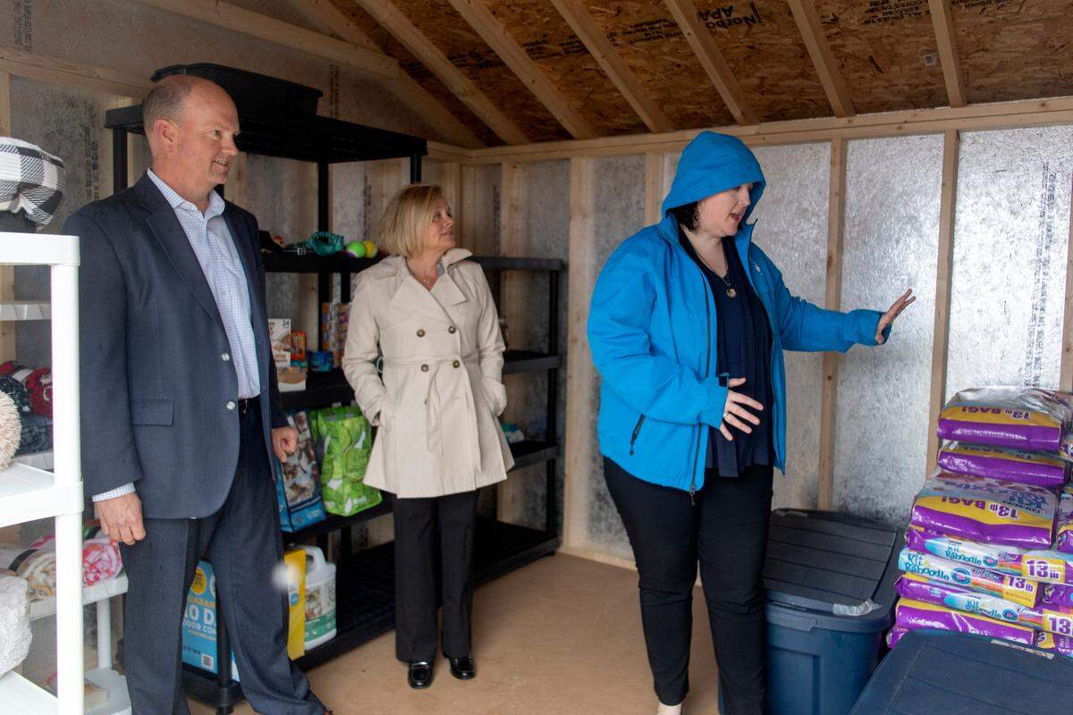 Centre County PAWS executive director Lisa Bahr shows Larry and Karen Walker around the Virginia Walker Pet Pantry on Thursday.