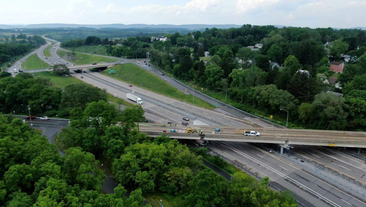 Crews work on the bridge on Elmwood Street that spans Route 322 on Tuesday, June 10, 2025.