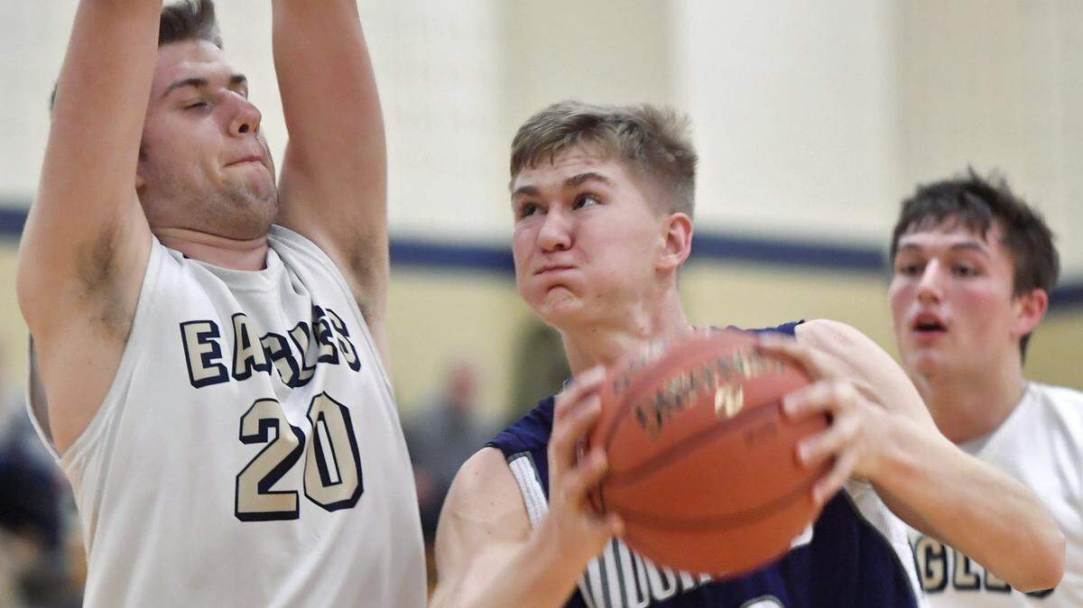 Philipsburg-Osceola’s Ryan Whitehead tries to go in for a basket around Bald Eagle Area’s Drew Bucha during a 2019 game.