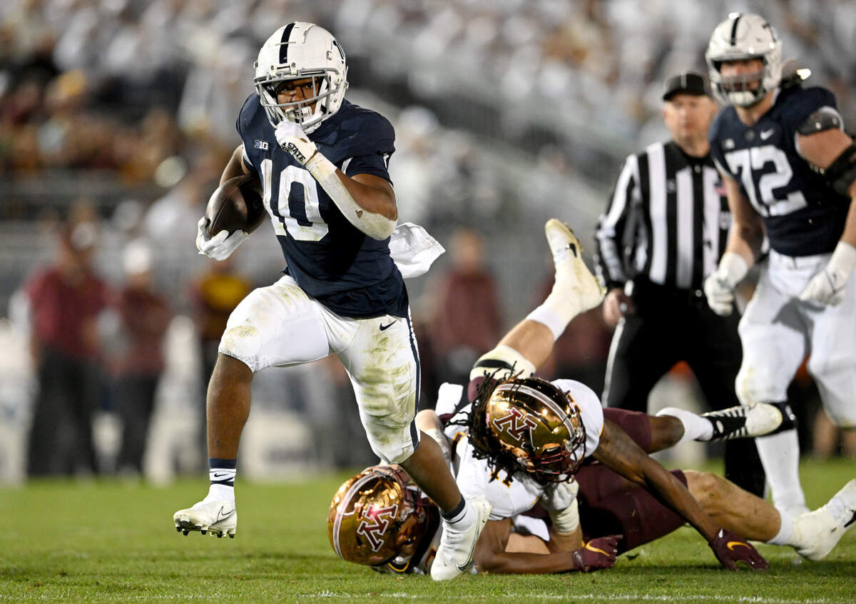 Minnesota defenders can’t stop Penn State running back Nick Singleton as he runs for a touchdown during the game on Saturday, Oct. 22, 2022.