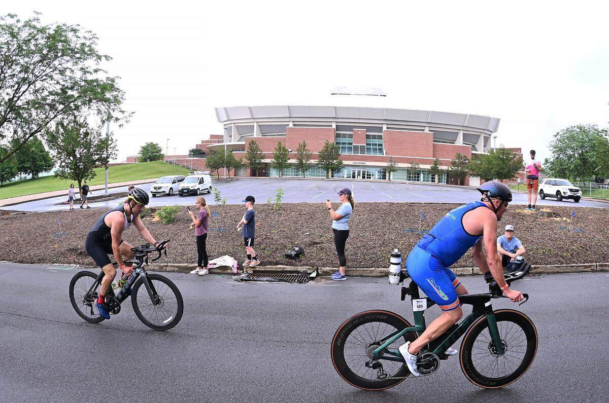 Participants in the Ironman 70.3 Pennsylvania Happy Valley finish the bike portion outside the Bryce Jordan Center on the Penn State campus Sunday, July 2, 2023.