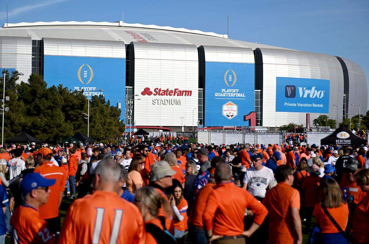 Boise State and Penn State fans hang outside of State Farm Stadium before the Fiesta Bowl on Tuesday, Dec. 31, 2024.