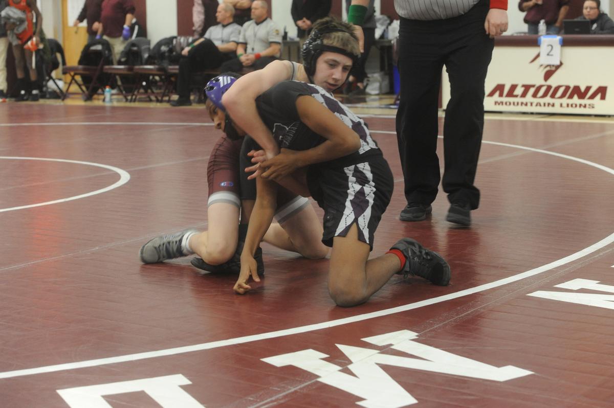 State College’s Mason Sanderson locks up a cradle on Obama Academy’s Mikel Jordan in their 107-pound first round match of the PIAA Class 3A Northwest Regional Championships on Friday, Feb. 24, 2023 in Altoona. Sanderson pinned Jordan in 1:44.