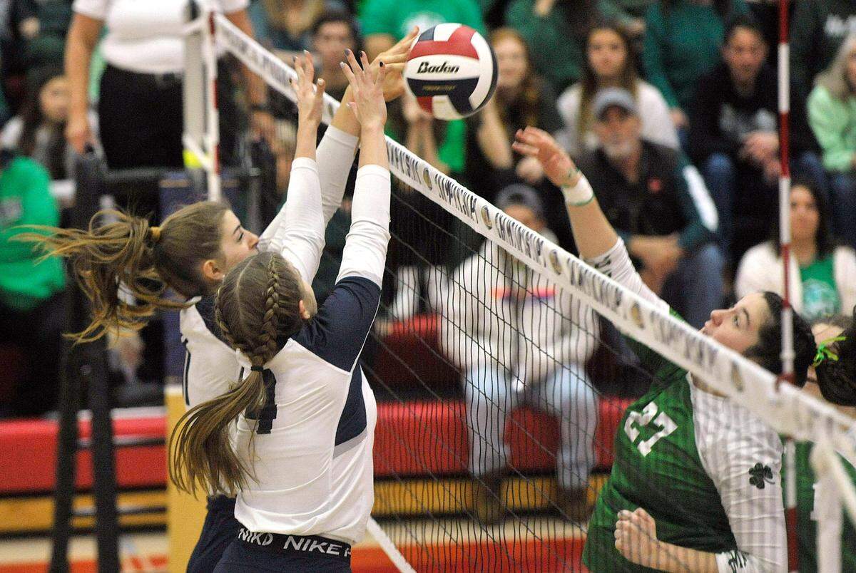 P-O’s Ava Ropert blocks the shot of Trinity’s Melissa Zack (27) with help from P-O’s Emily Gustkey. The Philipsburg-Osceola girls volleyball team won the PIAA Class 2A state championship Saturday at Cumberland Valley in Mechanicsburg. P-O defeated Trinity 3-1.