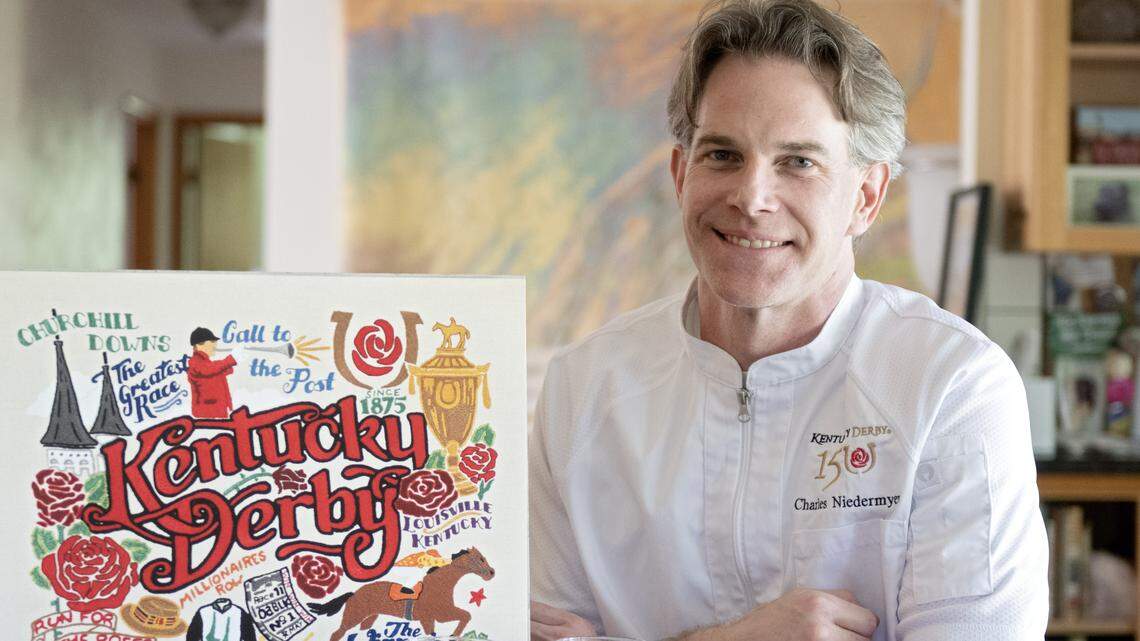 Chef Charles Niedermyer poses with some of his memorabilia from the Kentucky Derby. 