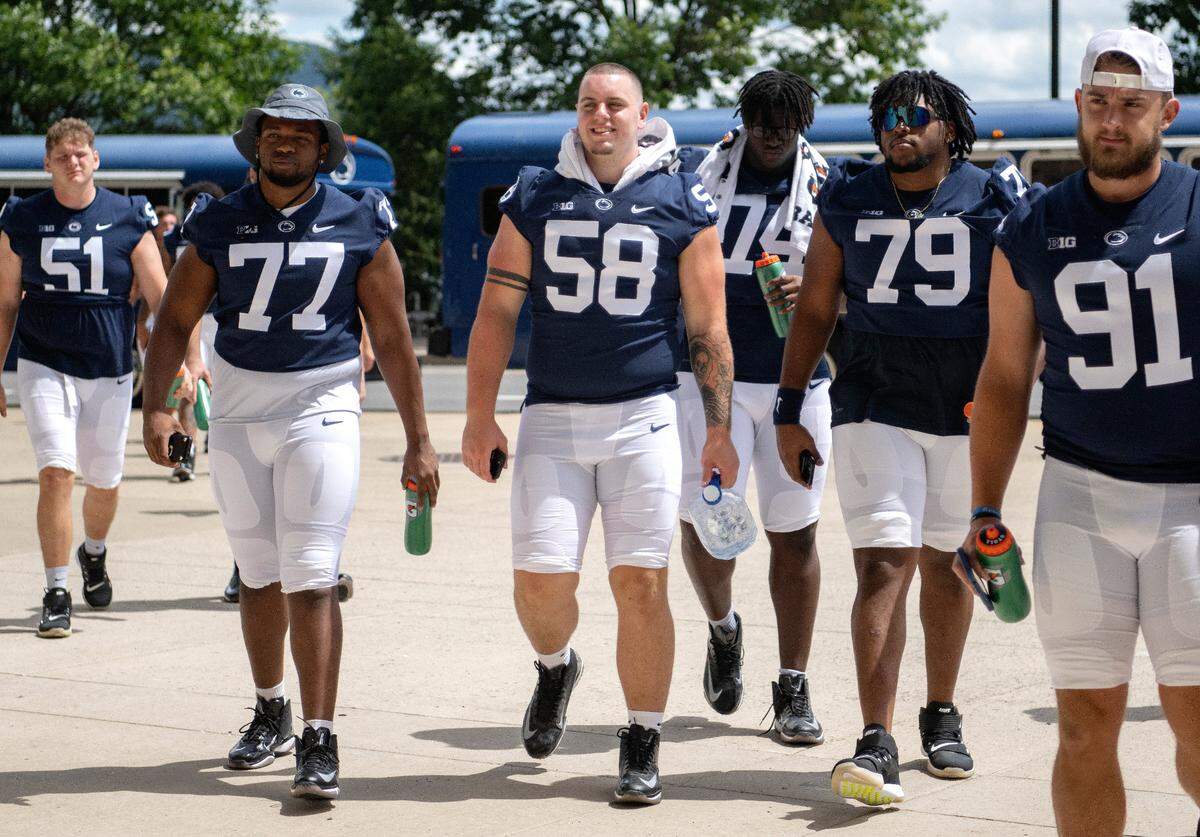 Members of the offensive line Sal Wormley, Landon Tengwall and Caedan Wallace chat together as they enter Beaver Stadium for media day on Saturday, Aug. 6, 2022.
