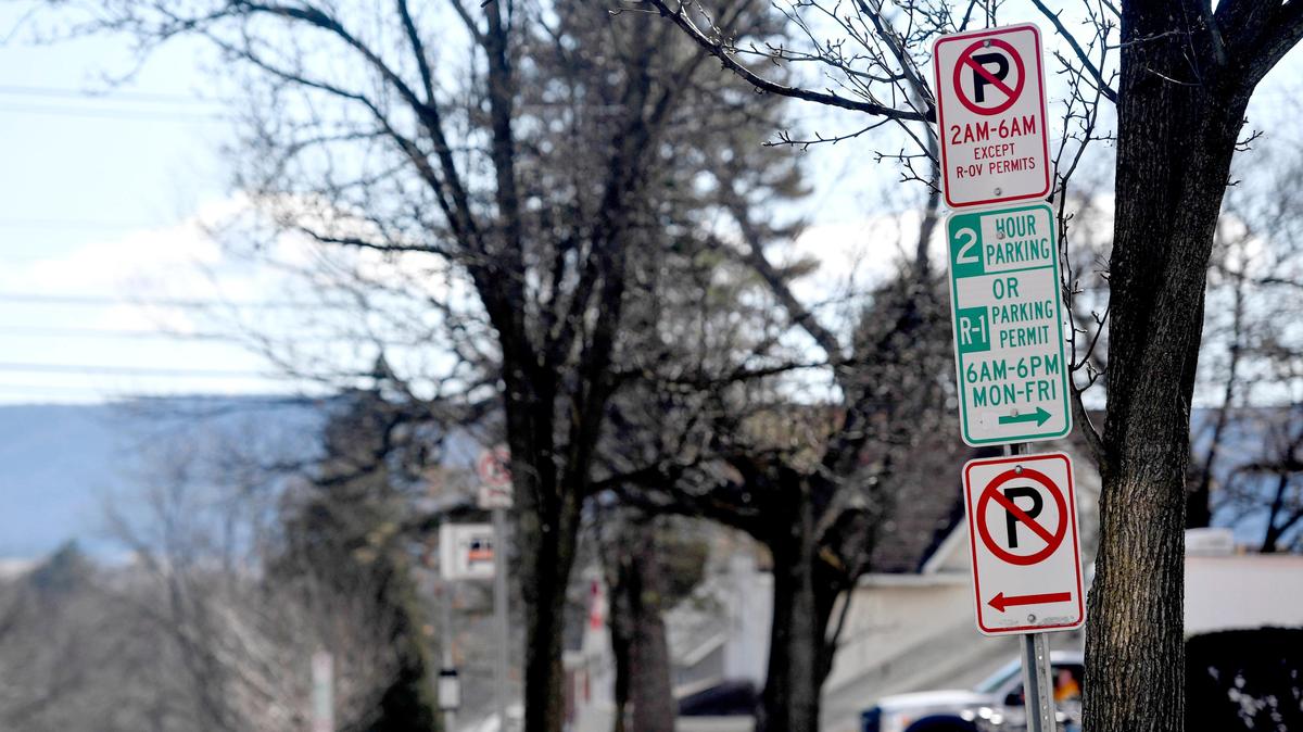 Parking signs on South Allen Street in the Highlands neighborhood on Wednesday, March 4, 2020. Neighborhood residents are asking for changes to the parking program after the first of a three-year pilot.