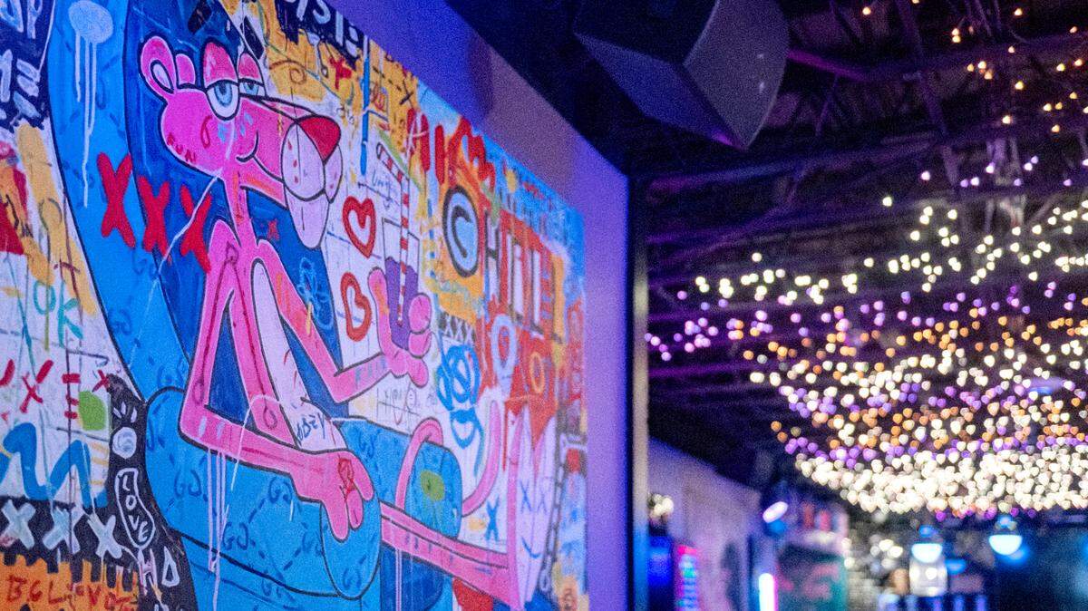 Colorful paintings and lights decorate The Hideaway in downtown State College.  