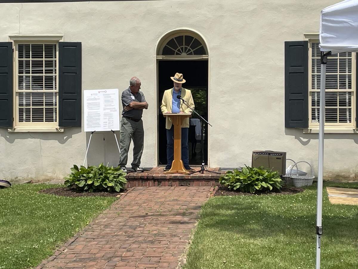 County Commissioners Steven Dershem and Mark Higgins give speech in front of Curtin mansion.