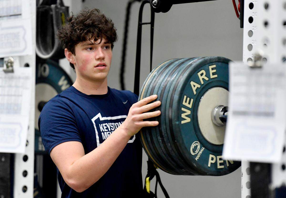 Penn State early enrollee Drew Allar adjusts the weights during a weight lifting session on Thursday, March 3, 2022.